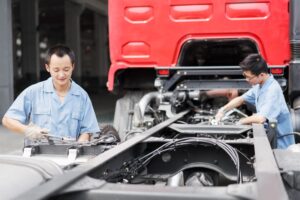 Asian Workers Fixing a Truck